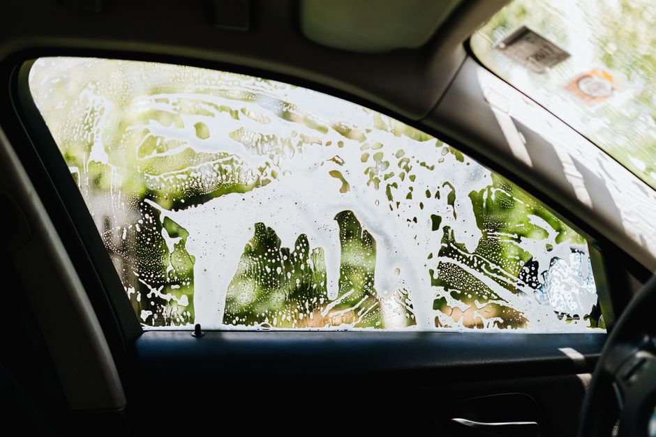 Rich soapy foam covering a car during a wash